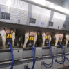 Modern milking parlor in action – cows lined up for automated milking in a high-tech dairy farm.